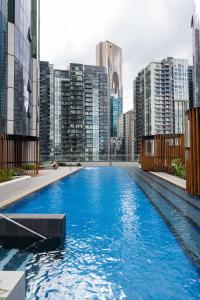 a large swimming pool in a city with tall buildings at City Lookout with Amenities in Melbourne