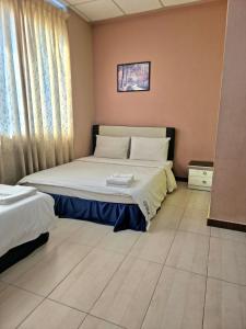 a bedroom with a large bed in a room at Destiny Riverside Hotel in Kota Bharu