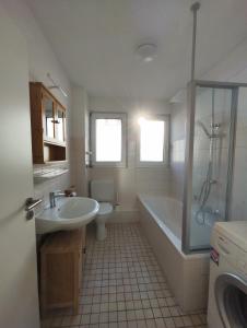 a bathroom with a tub and a sink and a shower at Silverstar in Sindelfingen