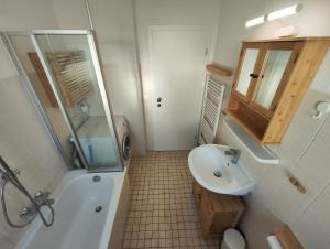 a bathroom with a sink and a shower and a toilet at Silverstar in Sindelfingen