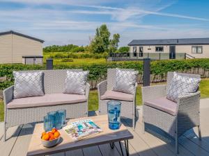 a patio with two chairs and a table with a bowl of fruit at 3 Bed in Brean 88890 in Berrow