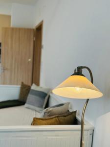 a lamp sitting on a table next to a couch at RiverGuard Apartment With FREE PARKING in Budapest