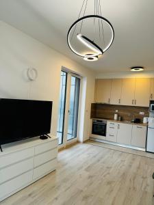 a large kitchen with a large flat screen tv at RiverGuard Apartment With FREE PARKING in Budapest