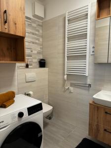a bathroom with a white toilet and a sink at RiverGuard Apartment With FREE PARKING in Budapest