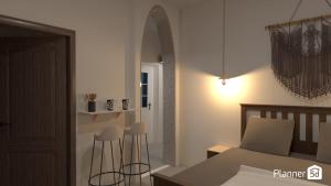 a bedroom with a bed and a table and stools at Alykes Studios & Suites in Agios Prokopios