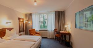 Postel nebo postele na pokoji v ubytování Hotel Olympic