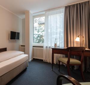 Postel nebo postele na pokoji v ubytování Hotel Olympic