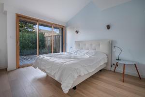 a bedroom with a bed and a large window at Pause, detente et partage a Pornichet in Pornichet