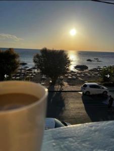 a cup of coffee on a table with a view of the ocean at Stegna Sea & Sun in Archangelos