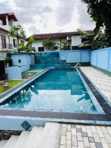 a swimming pool in front of a house at Villa Eco Green Airport in Katunayake