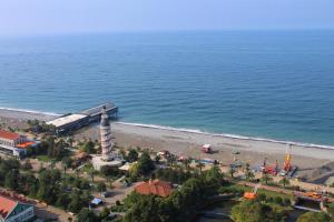 an aerial view of a beach with a lighthouse at Orbi City- Premium Class in Batumi