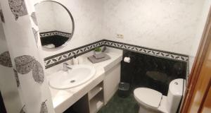 a bathroom with a sink and a toilet and a mirror at Casa Felix - Ferienwohnung in Esquinzo in Playa Jandia +7 photos
