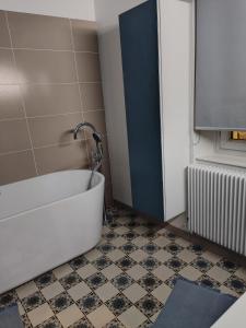 a bathroom with a tub and a tile floor at Plus Belle La Vue Allauch in Allauch