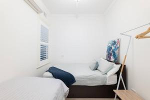 a small bedroom with a bed and a window at Cozy King Suite Millers Point in Sydney