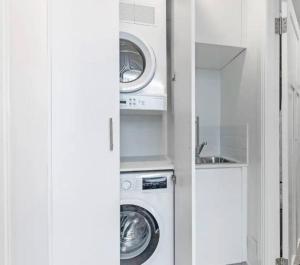 a kitchen with a washing machine and a sink at Cozy King Suite Millers Point in Sydney