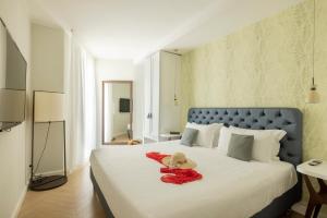 a bedroom with a bed with a teddy bear on it at BeSUITE Apartments in San Benedetto del Tronto