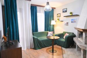 a living room with a green couch and a table at Hotel Ida in Bansko