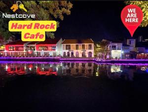a hard rock cafe is lit up at night at SOINN Jonker Guesthouse By Nestcove in Malacca