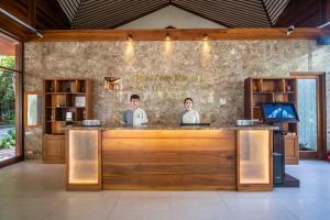 two chefs standing at a bar in a restaurant at Hon Tam Resort in Nha Trang