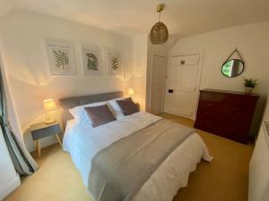 a bedroom with a large bed with two pillows at Knockfarrie Cottage in Pitlochry