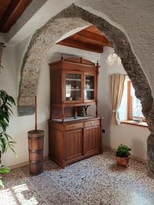 an archway in a room with a wooden cabinet at La Farie in Mediis