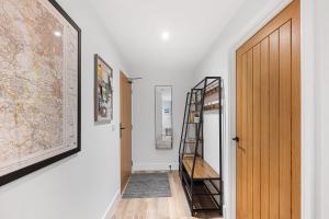 a hallway with a staircase and a door with a map at Rock Mill Apt 1 with Terrace in Stoney Middleton