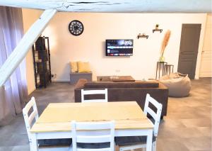 a living room with a table and a couch at La Sweet House Dorée Centre Ville Wifi Tout confort in Vitry-le-François