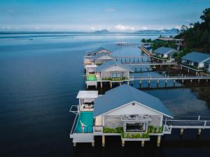 a row of houses on a dock in the water at Vedana Lagoon Resort & Spa in Hue