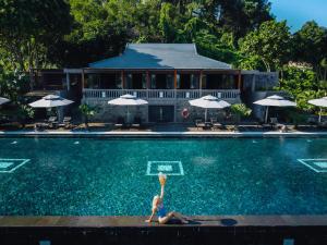 a woman is in the water in a swimming pool at Vedana Lagoon Resort & Spa in Hue +48 photos
