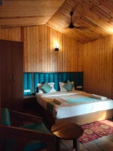 a bedroom with a large bed with a blue headboard at Oceano Beach Resort in Arambol