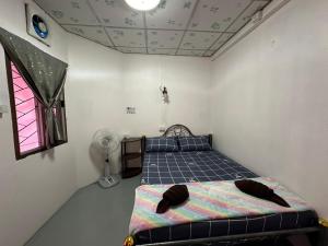 Katil atau katil-katil dalam bilik di Madam Guesthouse