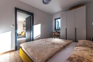 a bedroom with a large bed and a large mirror at Apartma Kadulja Golte in Mozirje