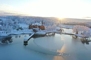 an aerial view of a lake with snow on it at Shepilska Relax Complex in Dolgoluka