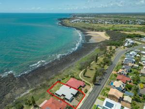 an aerial view of a beach with houses and the ocean at Baligara Absolute Oceanfront Guest Suite in Bargara