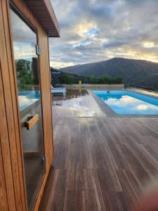 a view from the door of a house with a swimming pool at Miradores do Sil Hotel Apartamento in Cristosende