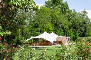 a tent in the middle of a garden with trees at Mas de Capelou in Avignon