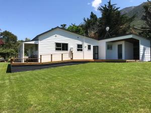 a house with a large yard in front of it at Kereru Cottage in Kaikoura