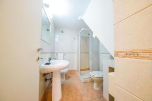 a bathroom with a sink and a toilet at Casa White by Wonderful Italy in Cefalù