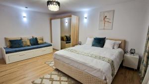 a bedroom with a large bed and a mirror at Central Modern View AP in Râmnicu Vâlcea