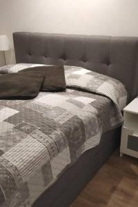 - un lit avec une couette et des oreillers dans l'établissement Gemütliches Garten-Apartment mit Bergblick, à Murnau am Staffelsee