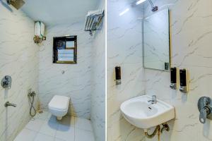 a white bathroom with a sink and a toilet at FabExpress Bindra Elite in Mumbai