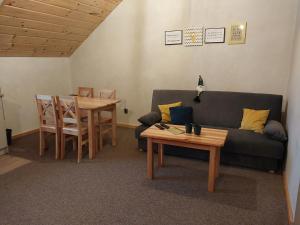 a living room with a couch and a table at Zwardoniówka Apartamenty pod Orawcową in Zwardoń