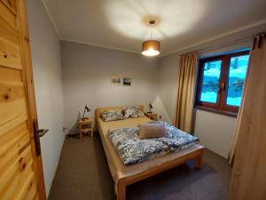 Postel nebo postele na pokoji v ubytování Zwardoniówka Apartamenty pod Orawcową