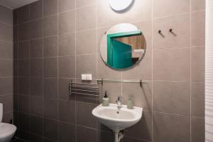 a bathroom with a sink and a mirror at 110 Hostel in Gdynia