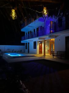 a night view of a building with a balcony at Sabali Lodge, Zanzibar in Jambiani