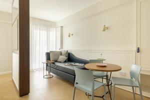 a living room with a couch and a table at BeSUITE Apartments in San Benedetto del Tronto