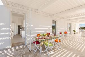 una casa bianca con tavolo e sedie di Dimora Seculari by Perle di Puglia a Mesagne