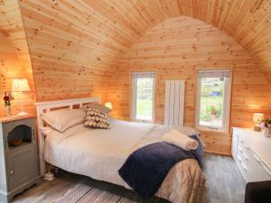 a bedroom with a bed in a wooden room at The Pod in Shrewsbury