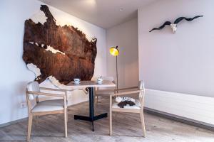 a room with a table and two chairs and a lamp at Estival Caribou Apartments in Pas de la Casa +16 photos