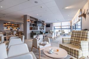 a waiting room with couches and chairs and tables at Estival Caribou Apartments in Pas de la Casa